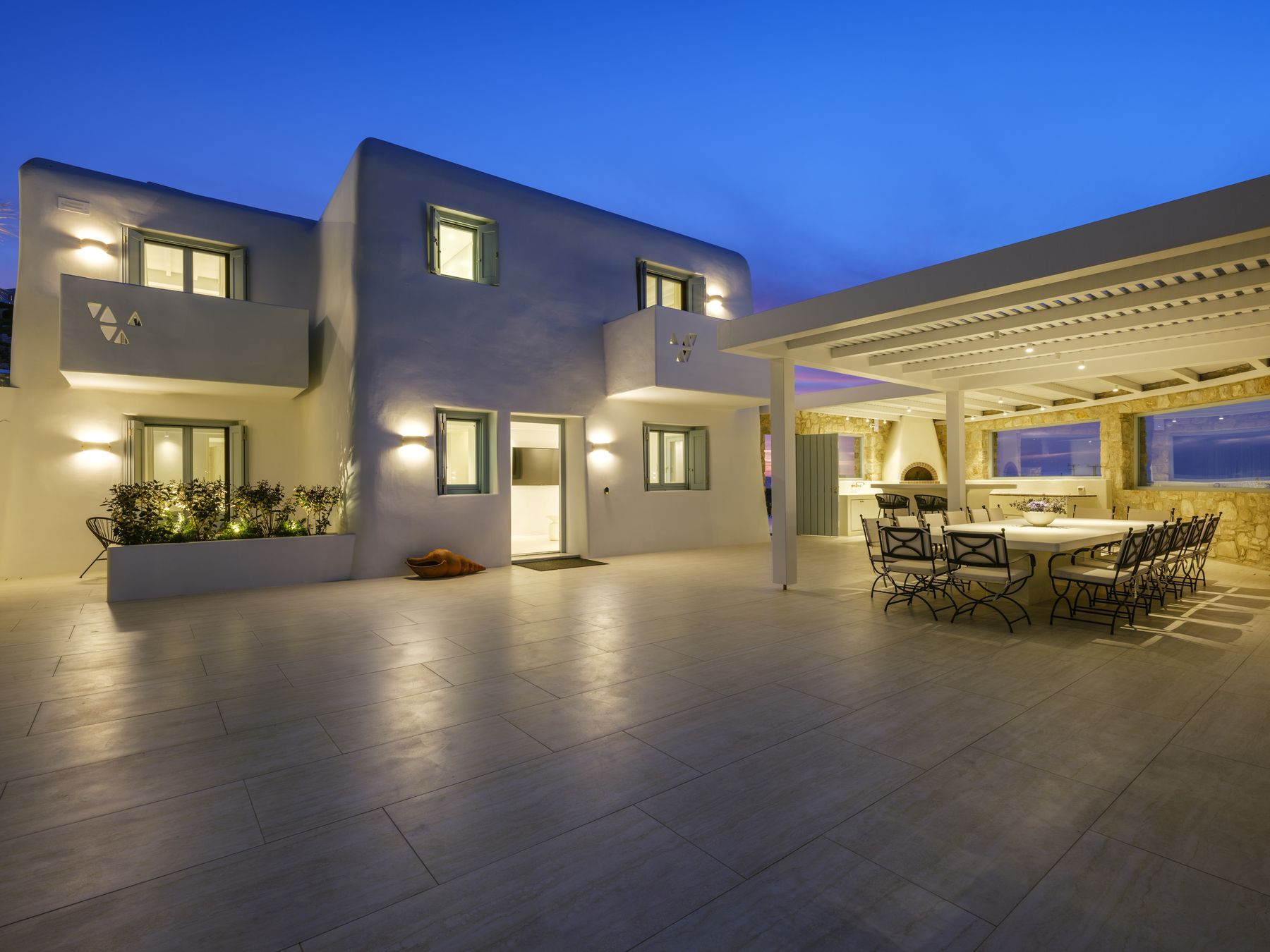 The house and pergola dining area at dusk