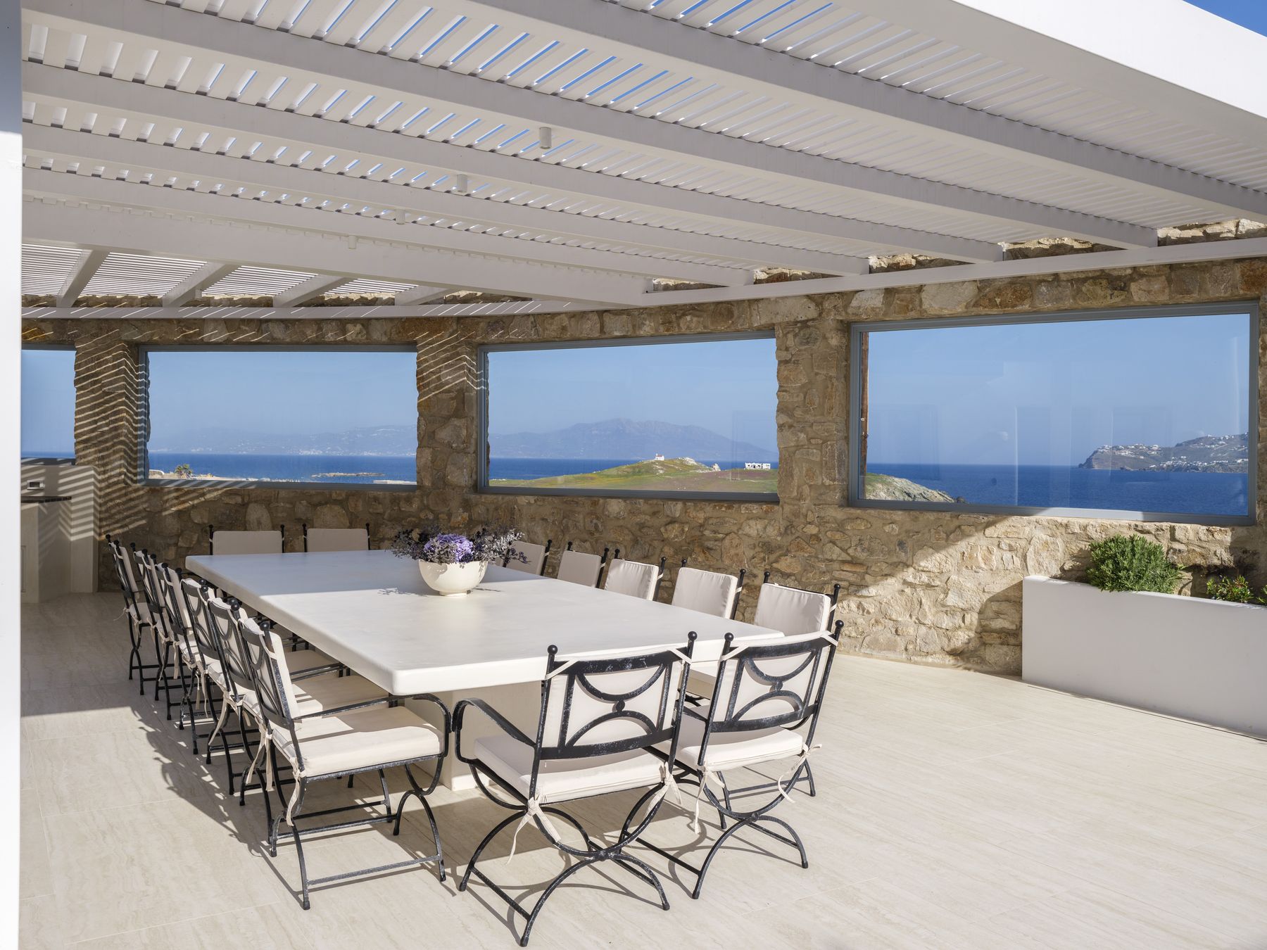 Dining table for 16 with stone walls and sea views