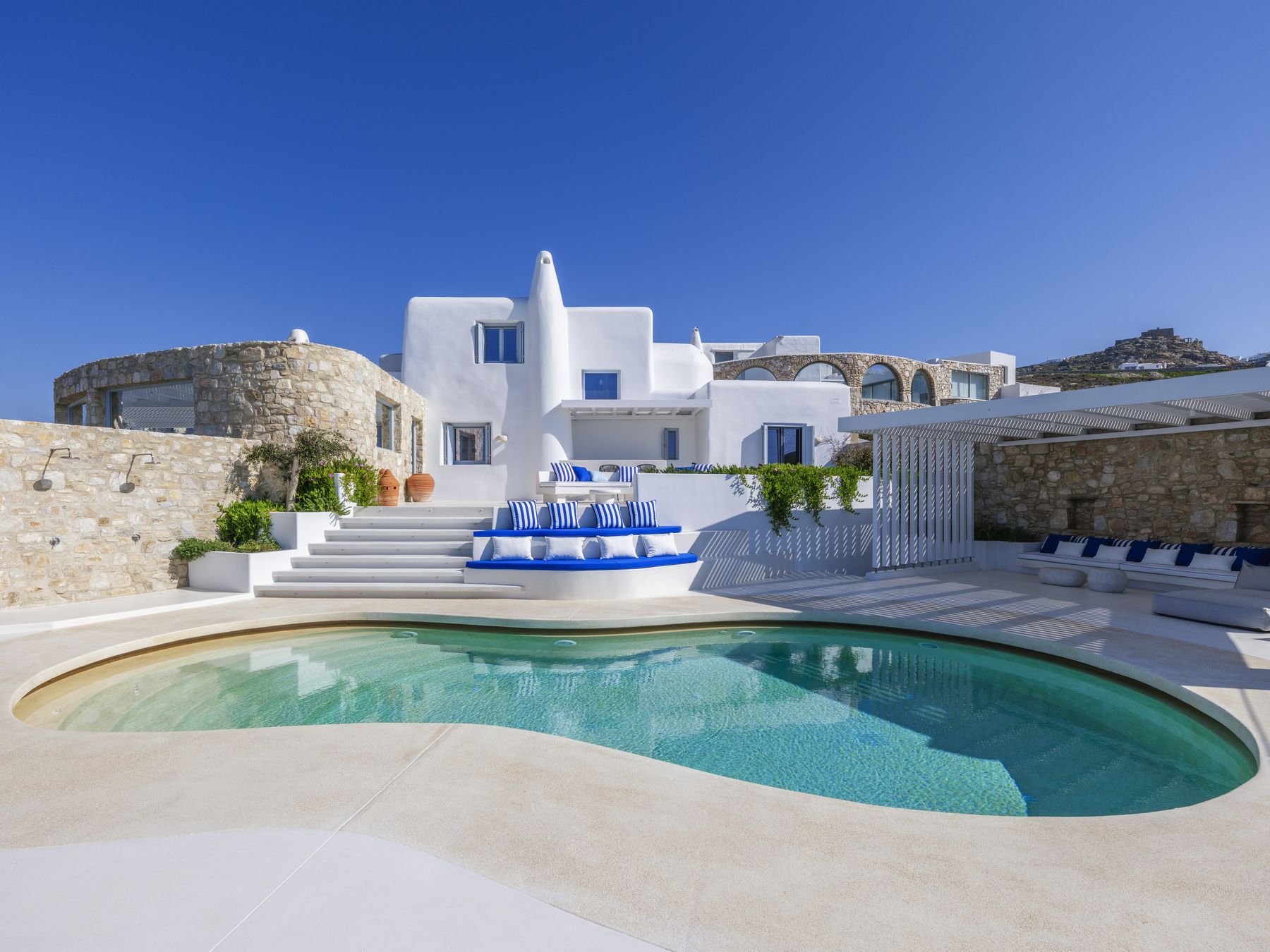 The pool and stepped terraces of Villa KIYA in daylight